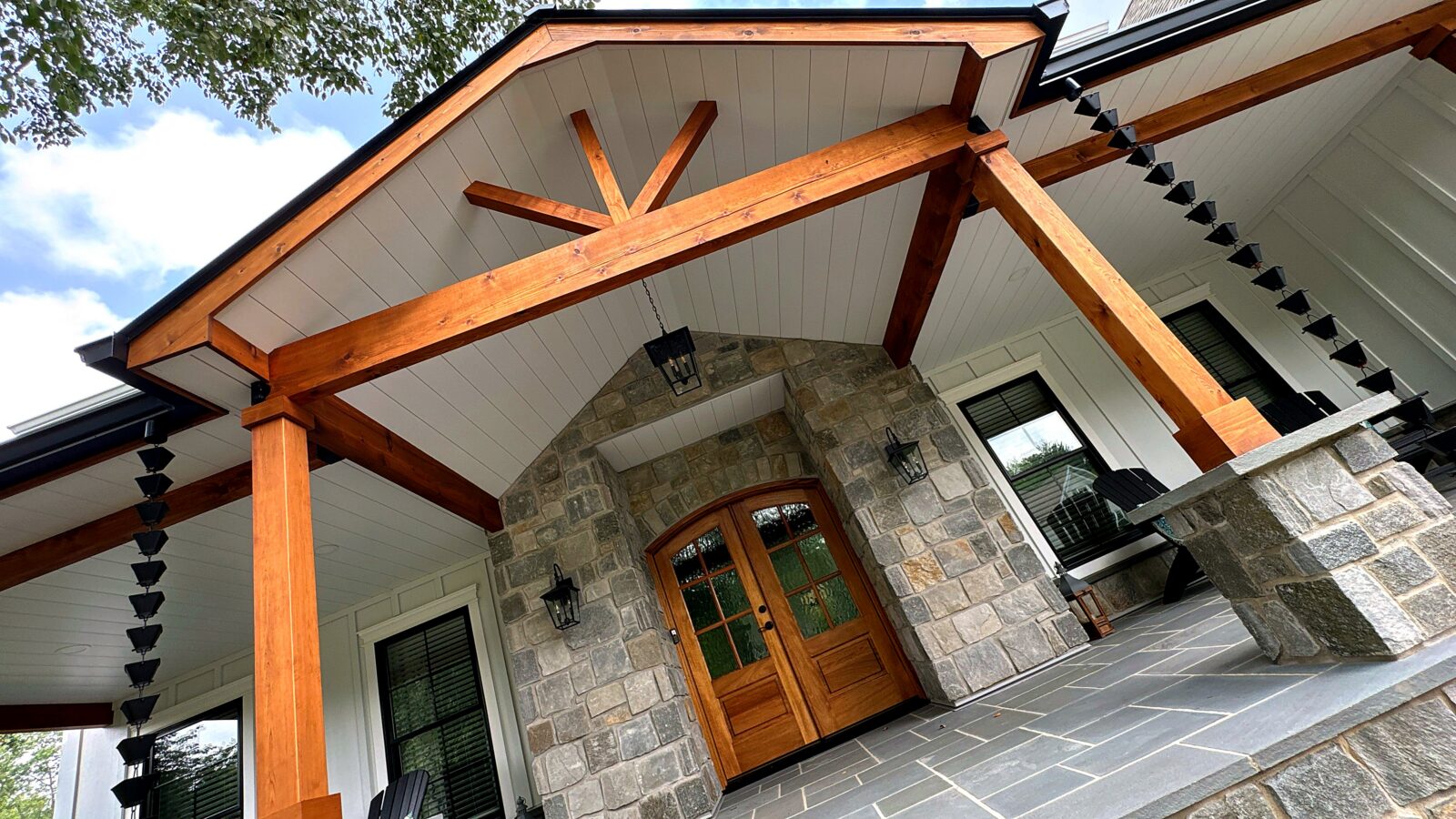 Porch ceiling, timber gable, stone column bases and hanging entry lantern